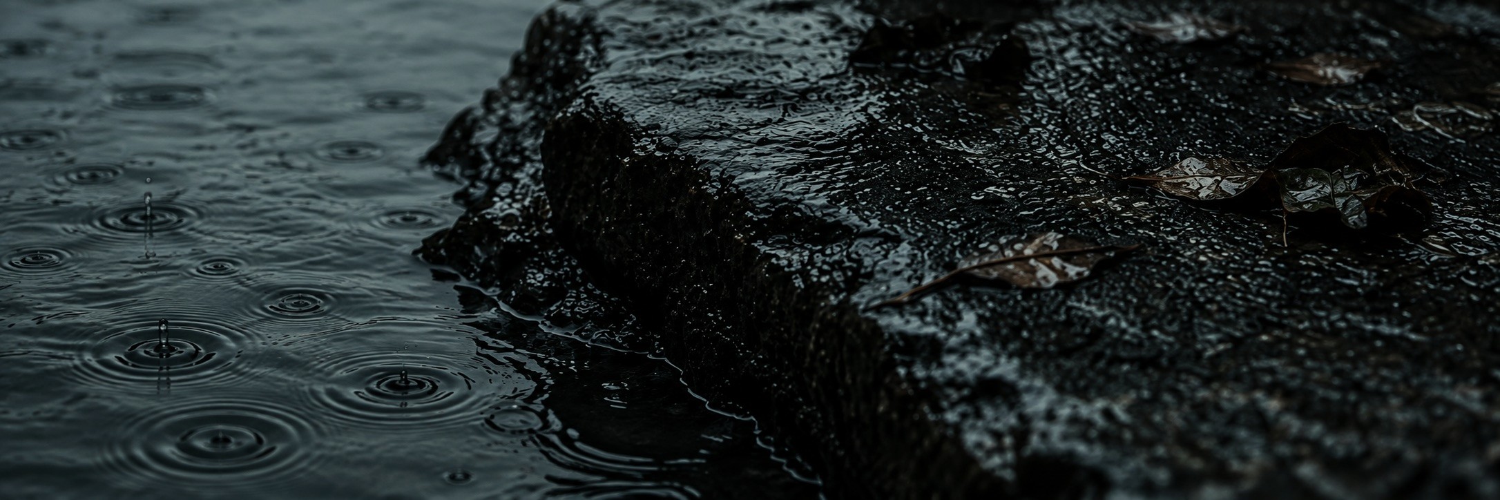Rain falling on still water